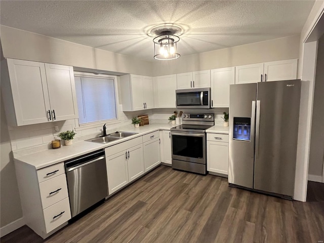 kitchen featuring white cabinets, dark hardwood / wood-style floors, sink, and appliances with stainless steel finishes