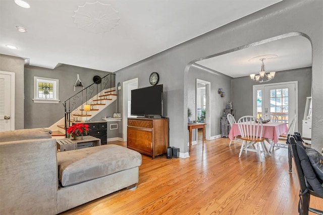 living room featuring an inviting chandelier and light hardwood / wood-style flooring