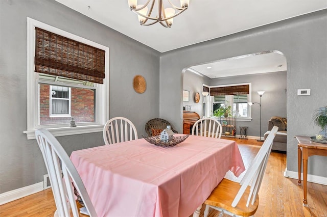 dining room featuring a notable chandelier and light hardwood / wood-style flooring