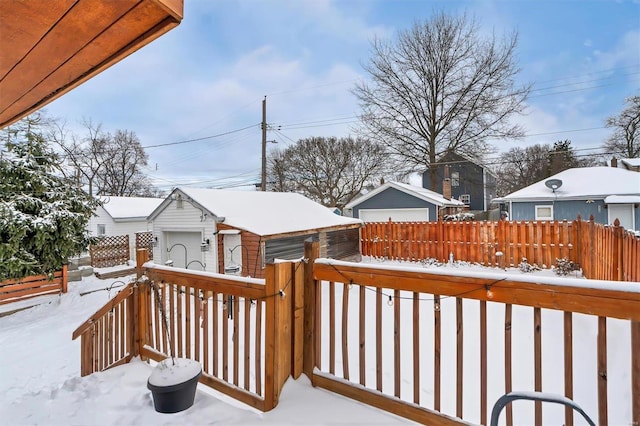 snow covered deck featuring a garage