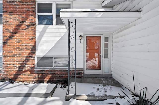 view of snow covered property entrance