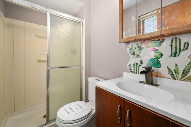 bathroom featuring a stall shower, vanity, and toilet