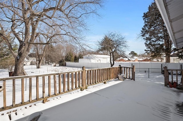 snow covered deck with fence