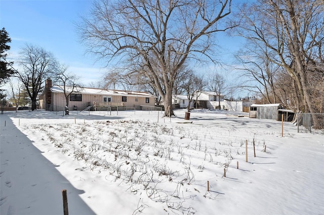 snowy yard with fence