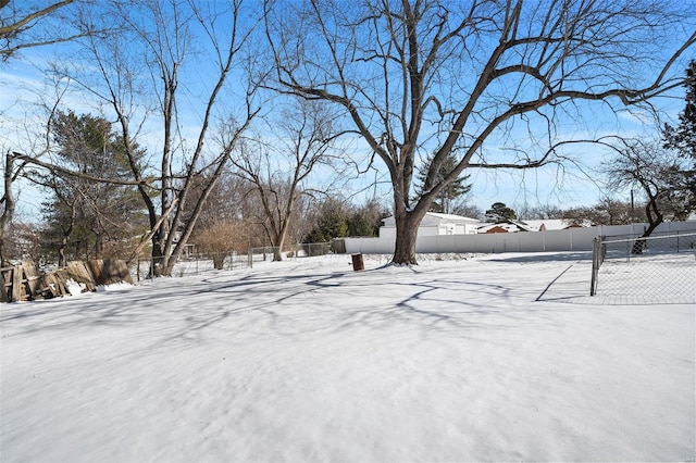 snowy yard with fence