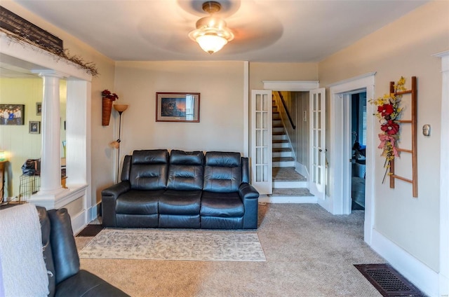 carpeted living room featuring ceiling fan and ornate columns