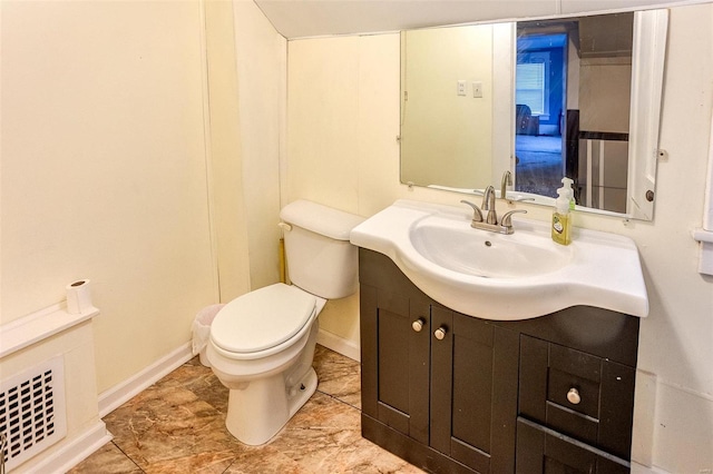 bathroom featuring vanity and toilet