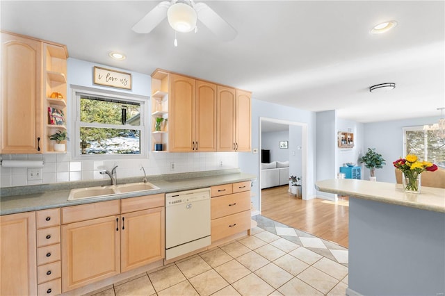 kitchen with light tile patterned floors, backsplash, light brown cabinetry, white dishwasher, and sink