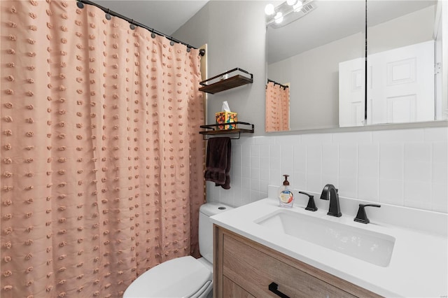 bathroom featuring toilet, tile walls, tasteful backsplash, and vanity