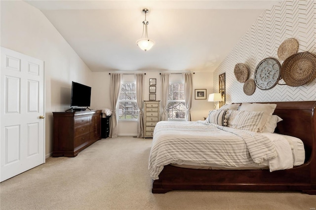 bedroom featuring lofted ceiling and light colored carpet