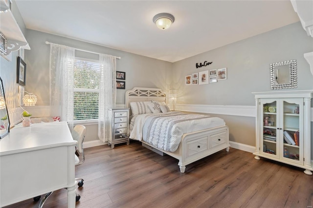 bedroom with dark hardwood / wood-style flooring