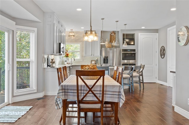 dining area with wood-type flooring and sink