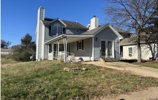 rear view of property featuring a yard