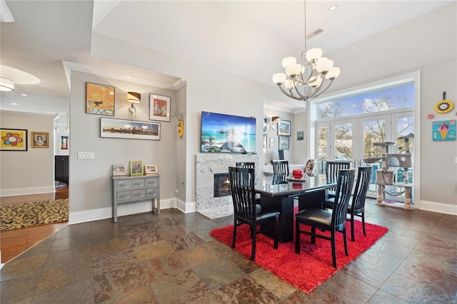 dining room with a chandelier and a premium fireplace