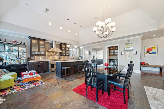 dining area featuring sink, an inviting chandelier, a raised ceiling, high vaulted ceiling, and crown molding