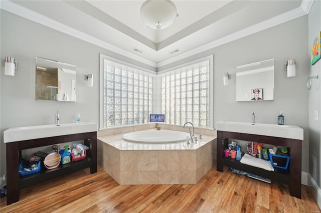 bathroom featuring crown molding, hardwood / wood-style floors, and vanity