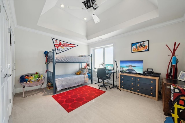 bedroom featuring a tray ceiling, crown molding, and light colored carpet