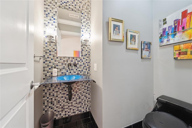 bathroom with sink, tile patterned flooring, backsplash, toilet, and ornamental molding