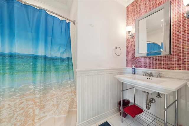 bathroom with tile patterned flooring, a shower with curtain, and crown molding