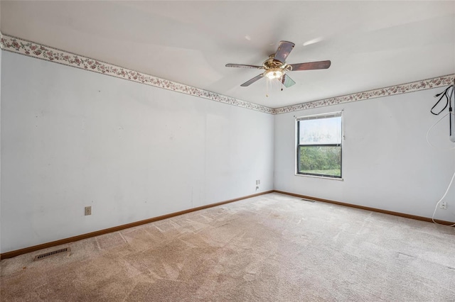 spare room featuring ceiling fan and light colored carpet