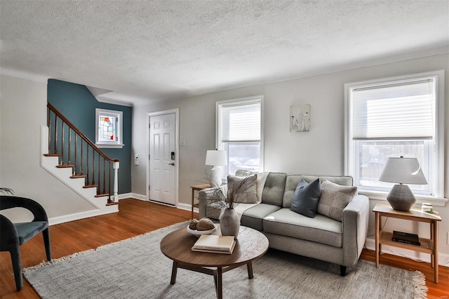 living room with hardwood / wood-style flooring and a textured ceiling