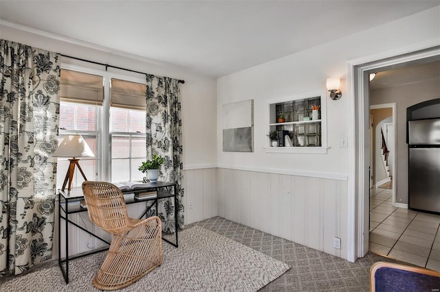 home office featuring tile patterned floors and wooden walls