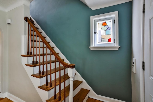 stairway featuring wood-type flooring