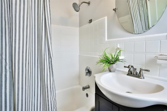 bathroom with vanity, shower / tub combo, and tile walls