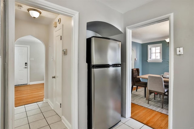 kitchen with stainless steel fridge and light tile patterned floors