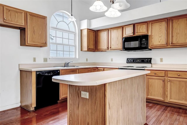 kitchen featuring a center island, sink, hanging light fixtures, dark hardwood / wood-style flooring, and black appliances