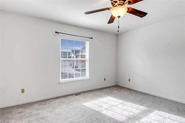 empty room featuring light carpet and ceiling fan