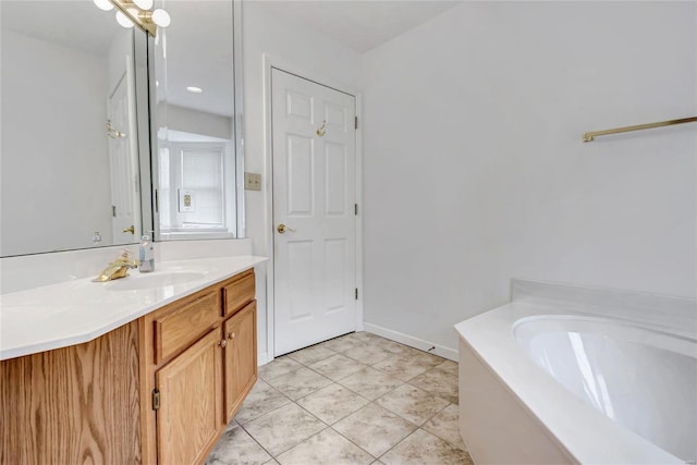 bathroom with tile patterned flooring, vanity, and a bathtub