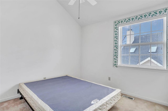 unfurnished bedroom featuring carpet, ceiling fan, and lofted ceiling