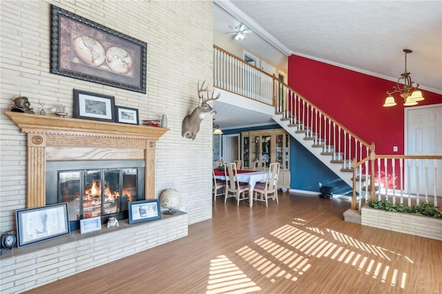 unfurnished living room with wood-type flooring, lofted ceiling, crown molding, and a chandelier