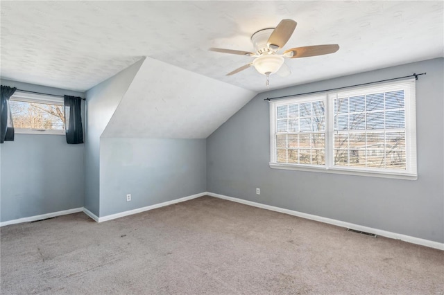 bonus room featuring ceiling fan, light colored carpet, and lofted ceiling