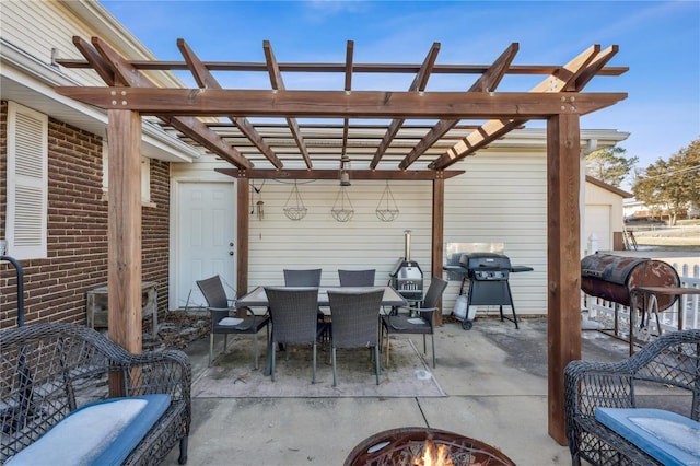 view of patio / terrace with an outdoor fire pit, area for grilling, and a pergola