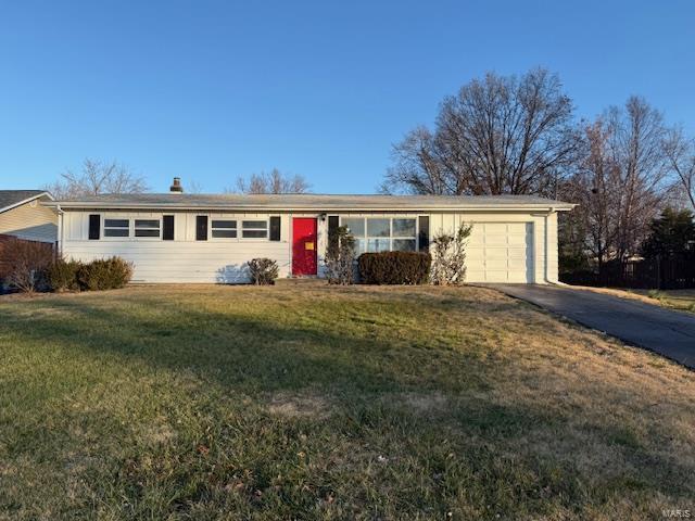 ranch-style home with a front lawn and a garage