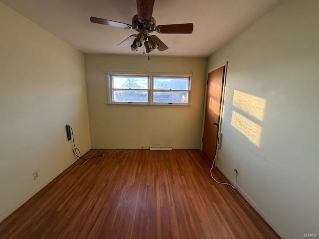 spare room with ceiling fan and hardwood / wood-style flooring