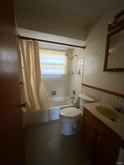 full bathroom with vanity, toilet, and shower / bath combo with shower curtain