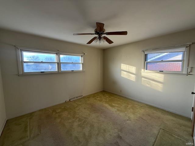 unfurnished room featuring carpet floors, ceiling fan, and a healthy amount of sunlight