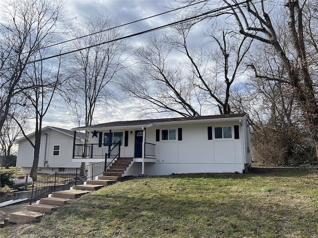 view of front of home featuring covered porch and a front lawn