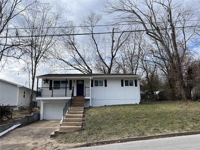 view of front facade with a garage, covered porch, and a front yard