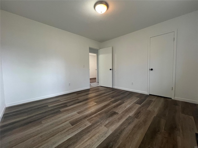 unfurnished bedroom with dark hardwood / wood-style floors