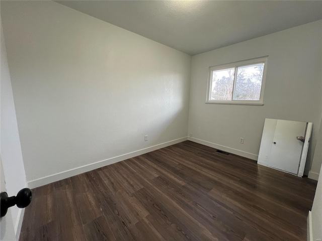 unfurnished room with dark hardwood / wood-style floors