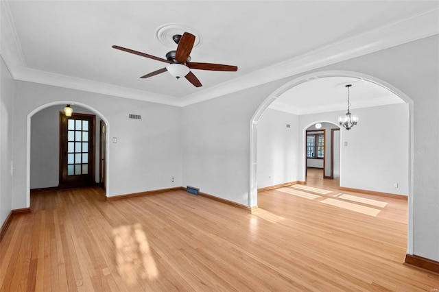 unfurnished living room featuring ornamental molding, ceiling fan with notable chandelier, and light wood-type flooring