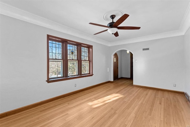 empty room featuring ornamental molding, ceiling fan, and light hardwood / wood-style flooring