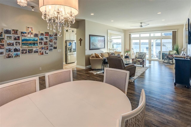 dining room with ceiling fan with notable chandelier, dark hardwood / wood-style floors, and french doors