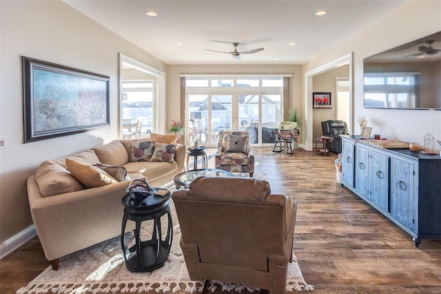 living room featuring hardwood / wood-style floors and ceiling fan