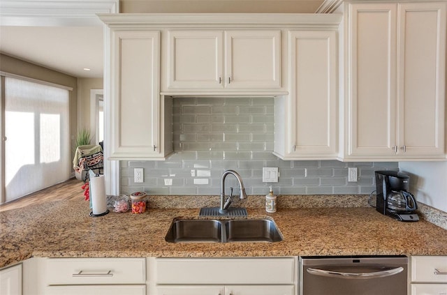 kitchen with dishwasher, white cabinets, and sink