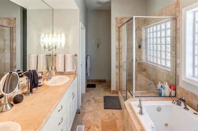 bathroom featuring vanity and independent shower and bath